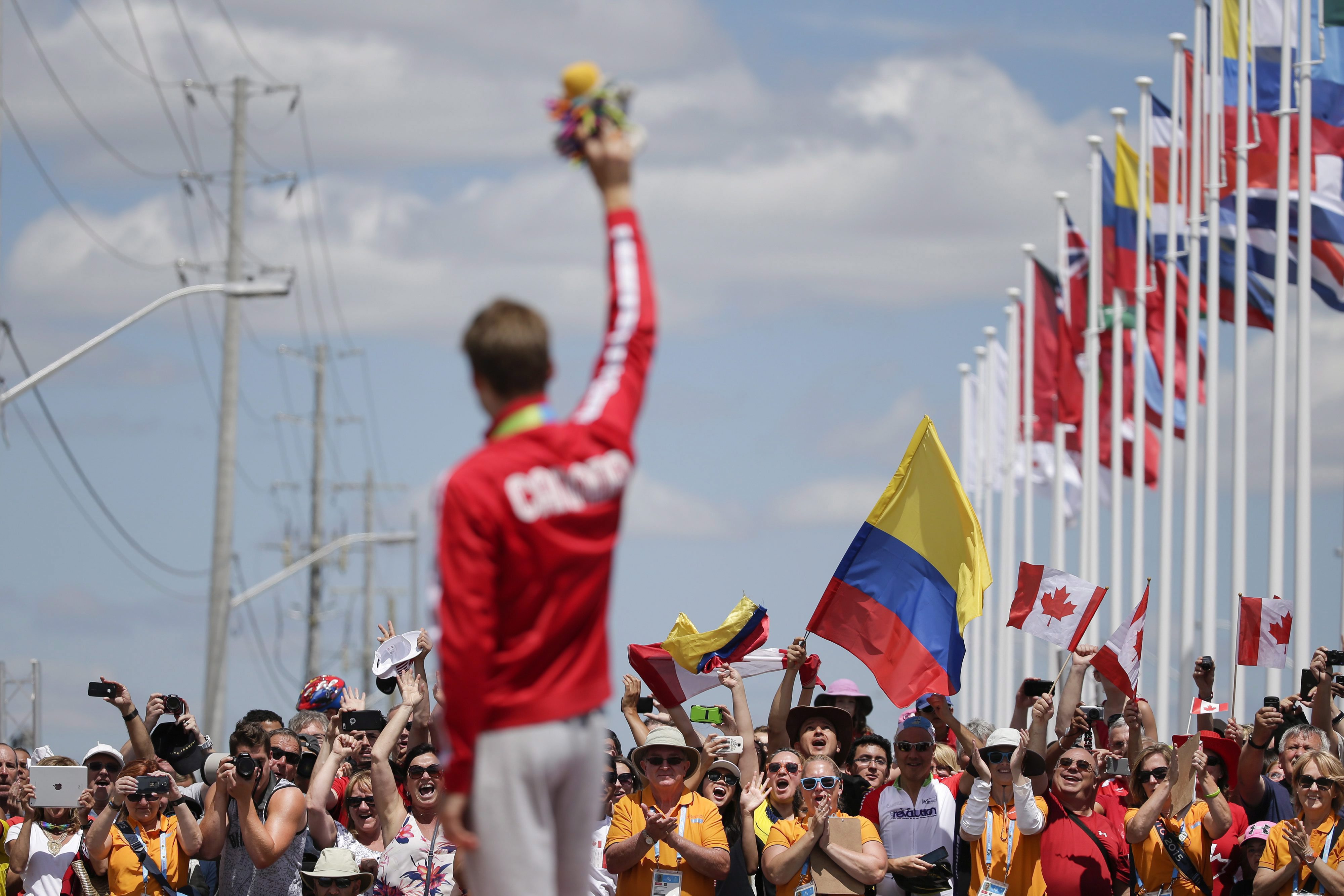 Houle sur le podium avec sa médaille d’or devant les partisans canadiens à Toronto 2015. (AP Photo/Felipe Dana)