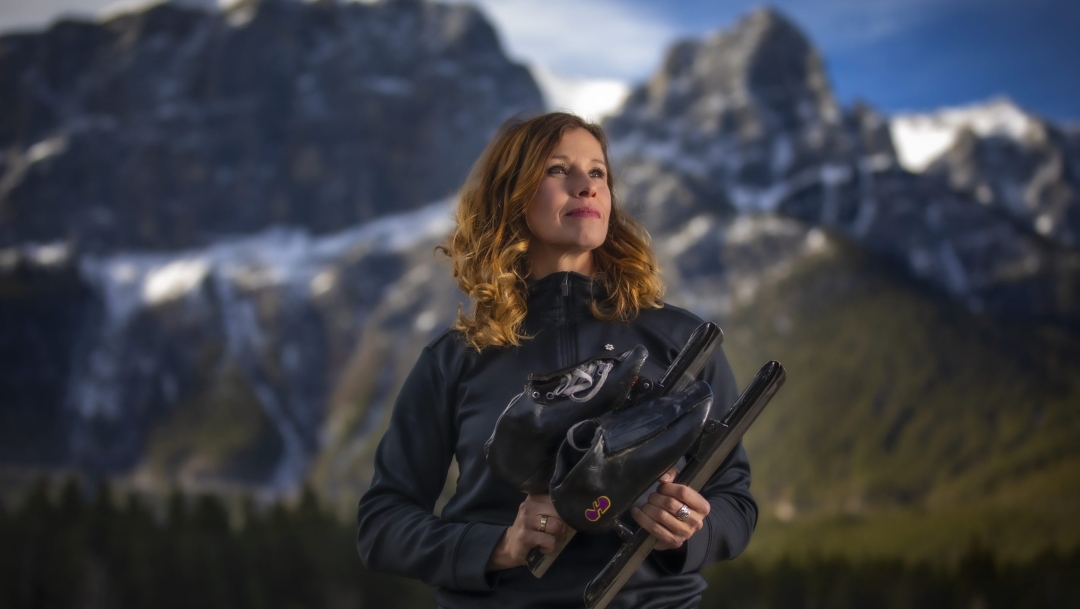 catriona Le May Doan devant un paysage de montagnes.