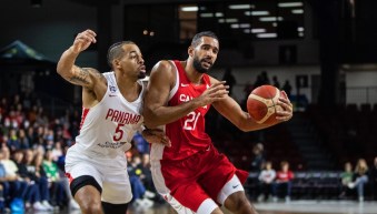 Deux joueurs de basketball se disputent le ballon.