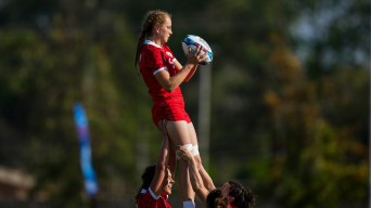 Carissa Norsten est soulevée par deux coéquipières.