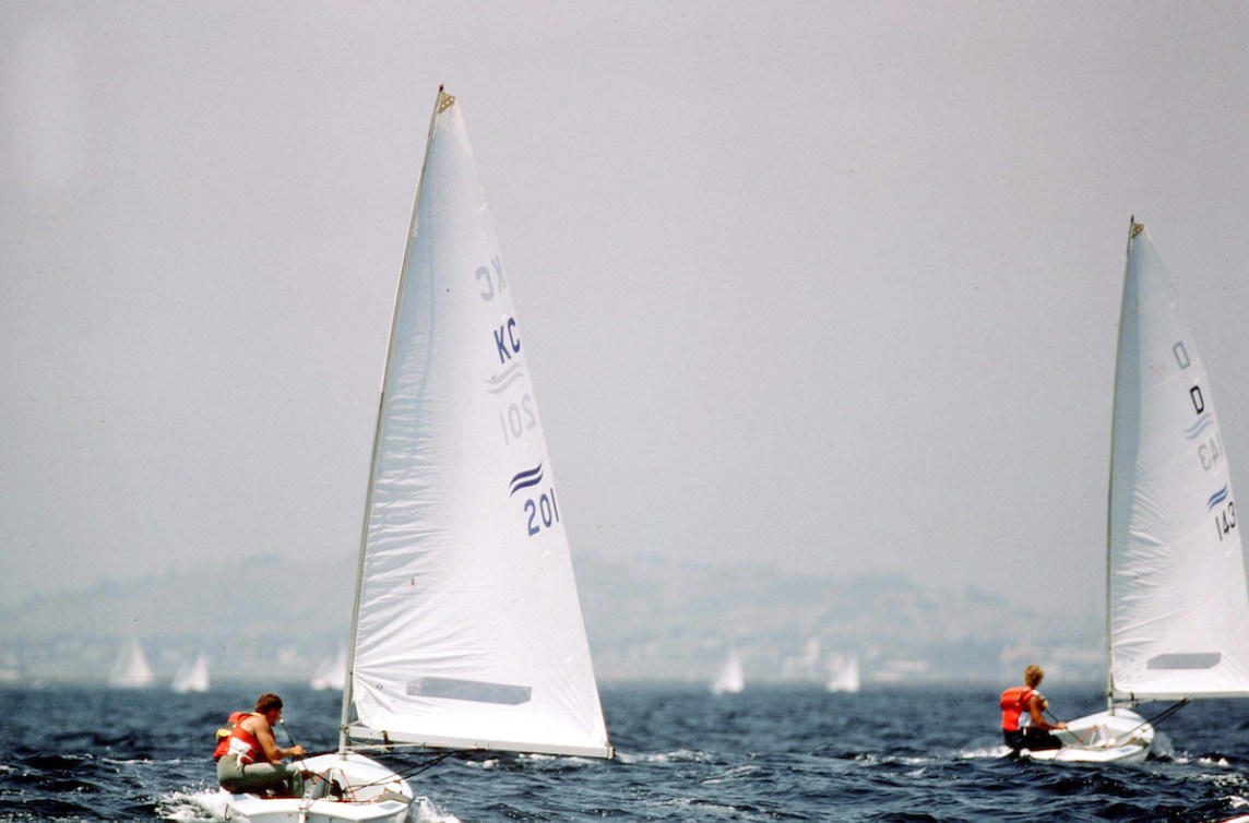 Two boats race in Olympic sailing competition in 1984 