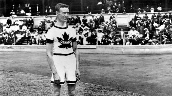 Canadian athlete standing in front of a crowd