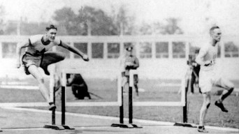 Earl Thompson competing in hurdles