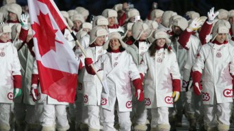 Athletes marching with the Canadian flag