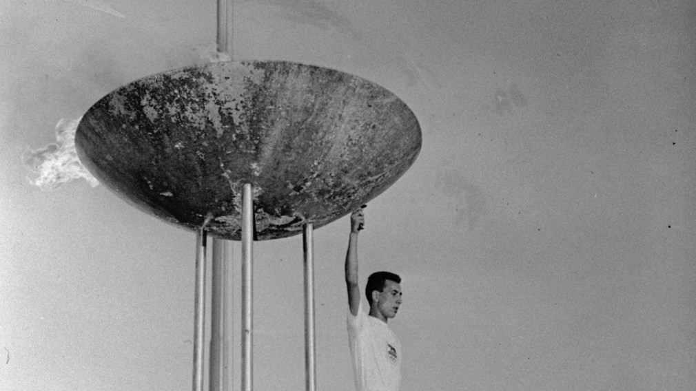athlete in front of the Rome 1960 torch