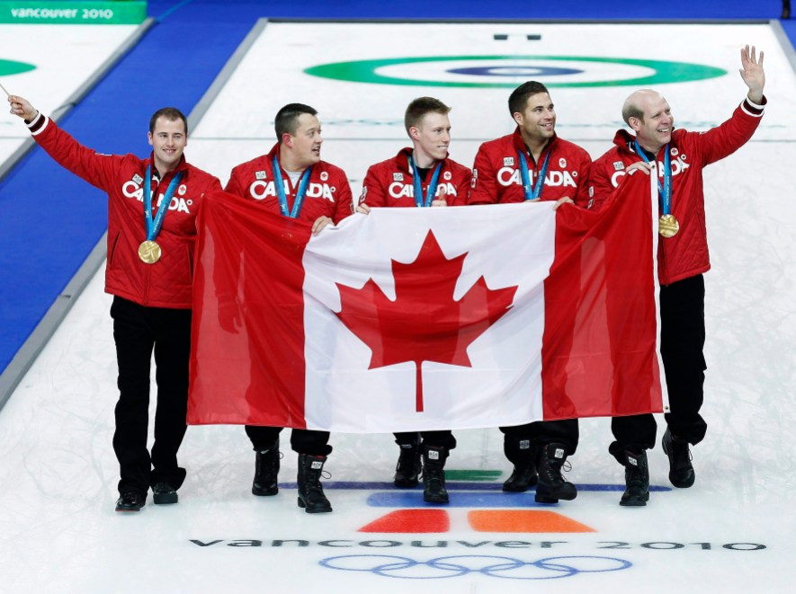 Curling - Men's Canada alternate Adam Enright, left to right, lead Ben Hebert second Marc Kennedy, third John Morris and skip Kevin Martin show off their gold medals after defeating Norway during Olympic men's curling finals action at the Olympic Centre on Saturday, Feb. 27, 2010 during the Olympic Winter Games in Vancouver. THE CANADIAN PRESS/Nathan Denette