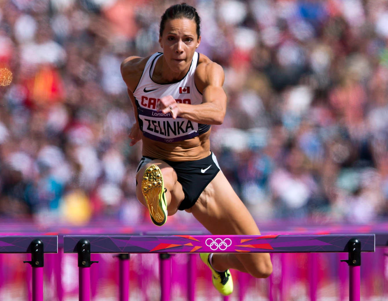 Jessica Zelinka clears the final hurdle during the 100m hurdles portion of Women's Heptathlon at the Olympic Games in London