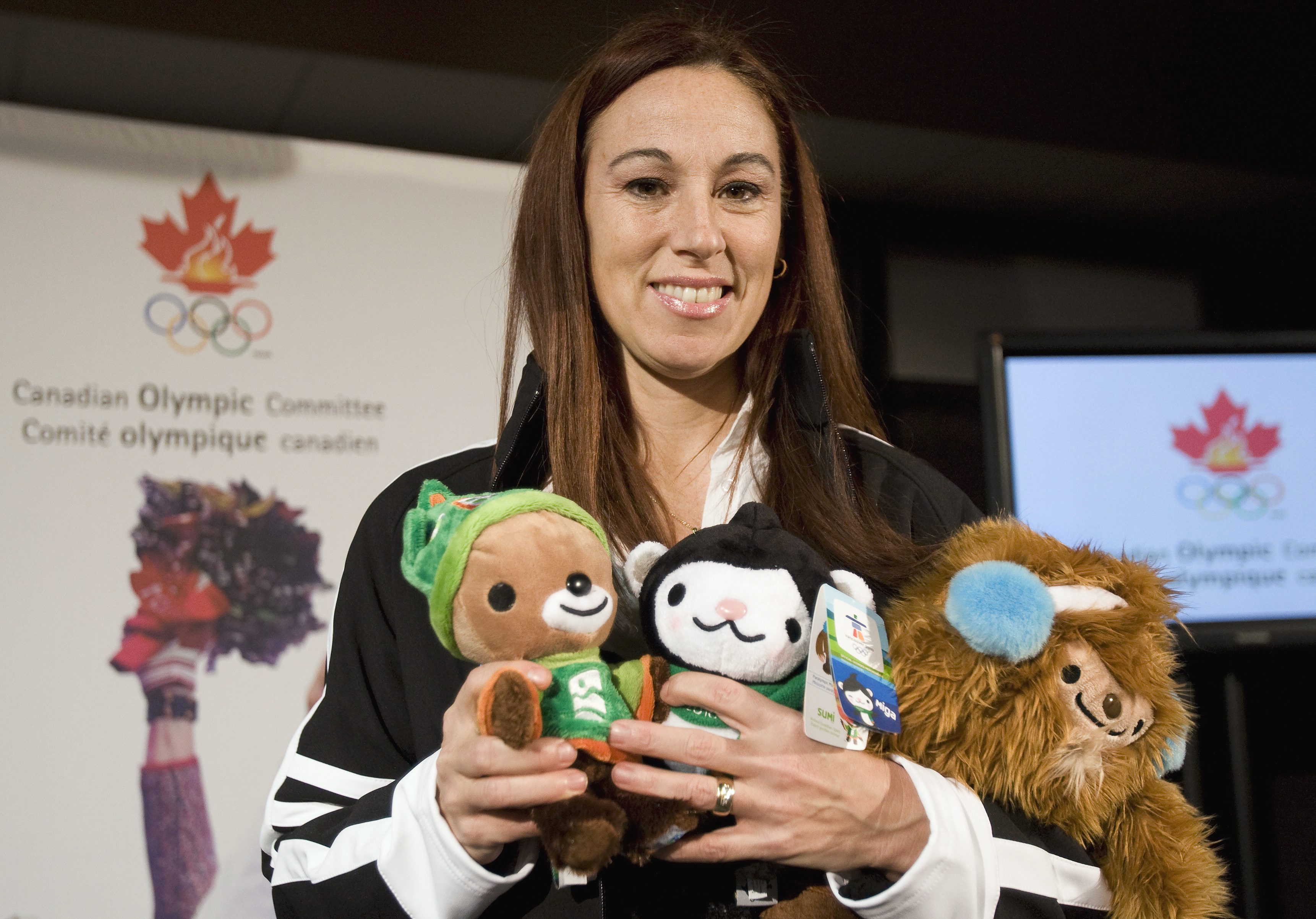 Nathalie Lambert holds the Vancouver 2010 mascots 
