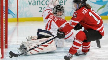 Hefford tries to put the puck behind the keeper