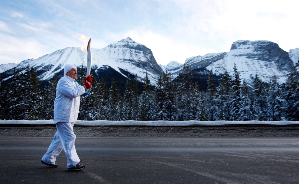 Torchbearer and former Alberta premier Peter Lougheed crosses into British Columbia from Alberta with the Vancouver 2010 Olympic flame