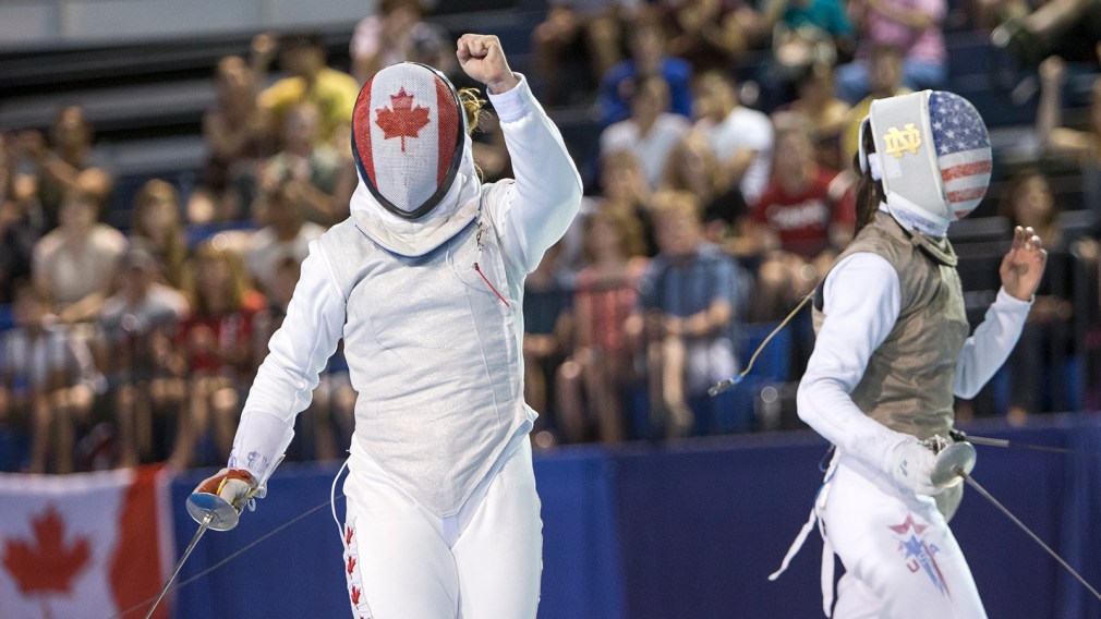Kelleigh Ryan celebrates winning a point against Lee Kiefer of the United States during the Team Women's Foil gold medal match at the Pan-American Games in Toronto