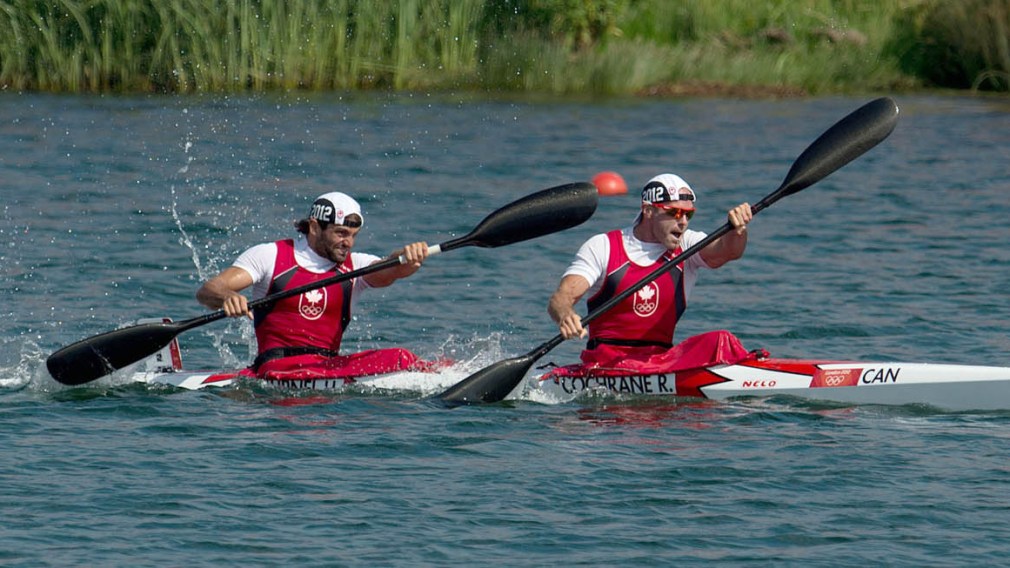 Cochrane and a teammate paddle together during a race