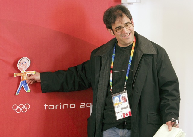 Randy Starkman poses with a drawing of himself at Turn 2006.