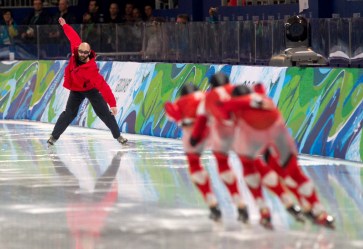 Coach Marcel Lacroix signals the men's team pursuit