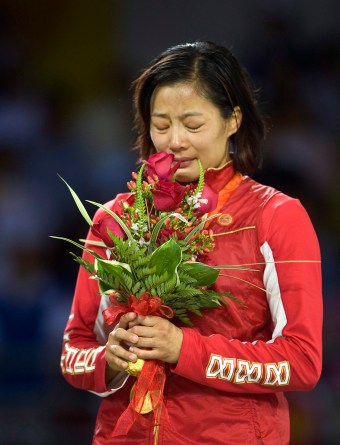 Carol Huynh cries into her flowers on the podium