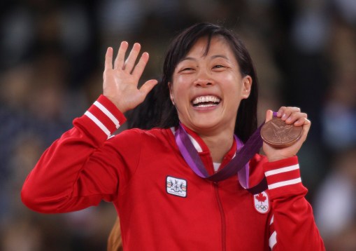 Carol Huynh celebrates her London 2012 bronze medal during presentation.