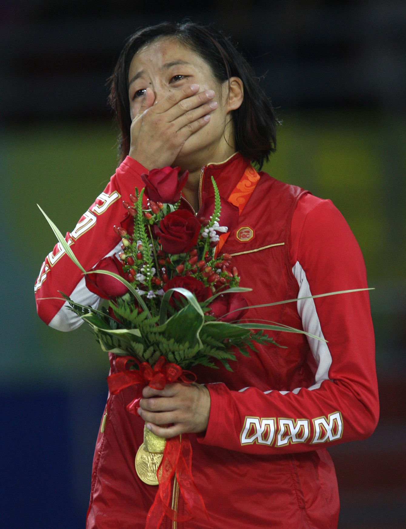 Crying listening to national anthem on podium