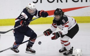 U.S. forward Jocelyne Lamoureux-Davidson (17) and Canada defender Laura Fortino (8) chase the puck