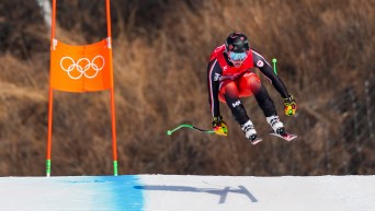 Trevor Philp goes over a jump in an alpine skiing race