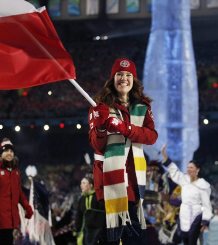 Hughes carrying Canadian flag in Opening Ceremony