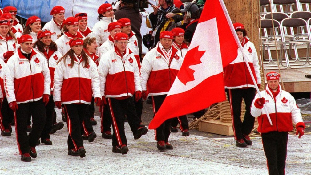 Canada's Jean-Luc Brassard carries the flag as the Canadian team participates in the opening ceremony at the 1998 Nagano Olympic Games.