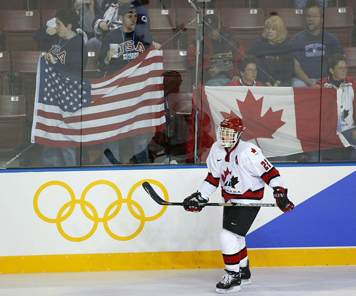 Canada's Hayley Wickenheiser, of Shaunavon, Sask., skates past US and Canadian fans during the warm-up prior to the gold medal ladies hockey game at the Olympic Winter Games in Salt Lake City, Utah, Thursday Feb. 21, 2002. (CP PHOTO/Paul Chiasson)