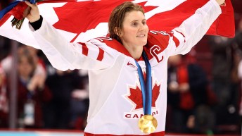 Hayley Wickenheiser celebrating with Canadian flag