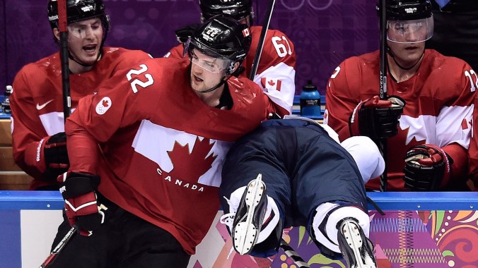 Jamie Benn dumps Phil Kessel at Sochi 2014 Jamie Benn finishes a check on Phil Kessel.