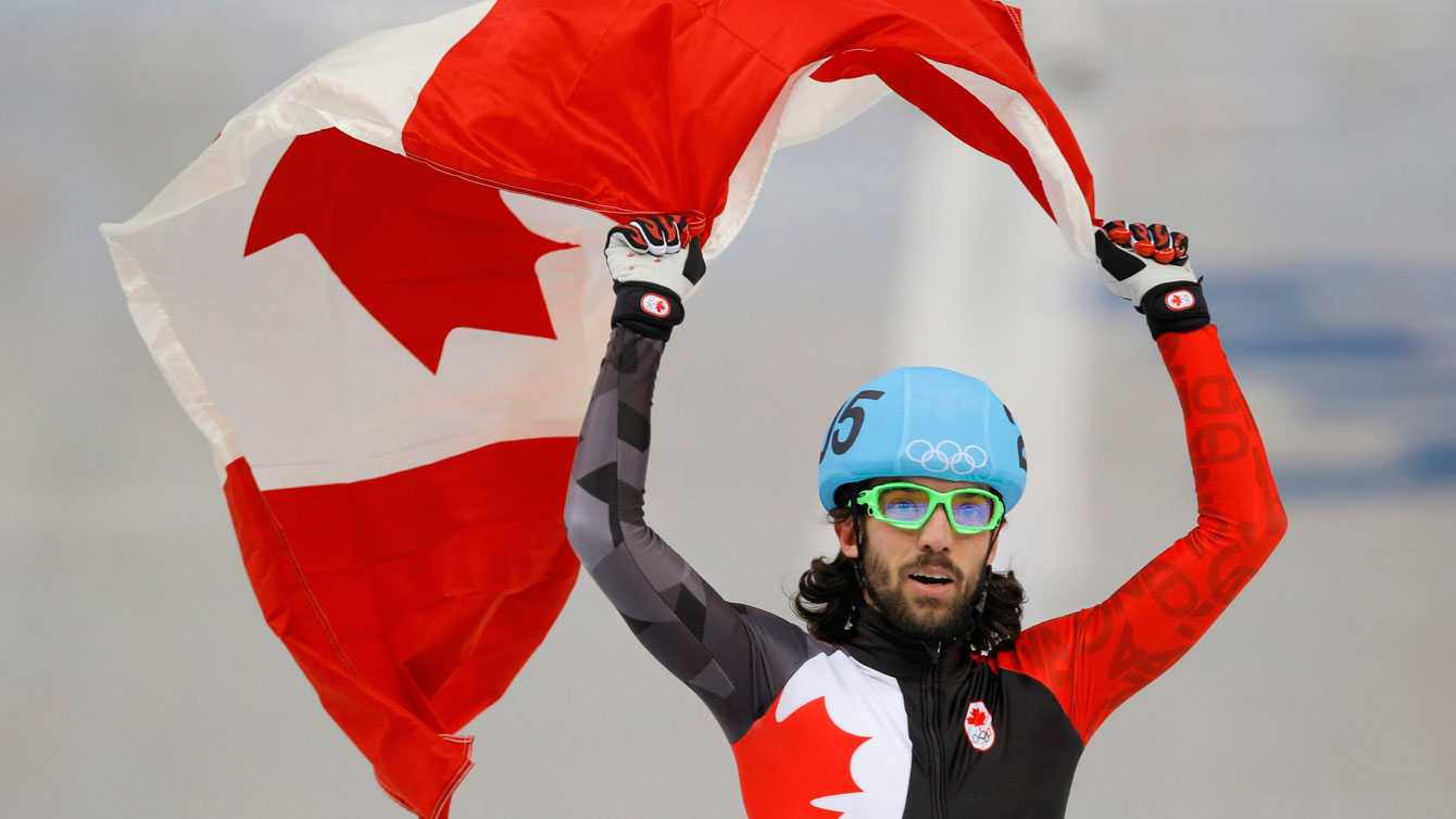 Charles Hamelin celebrating with flag