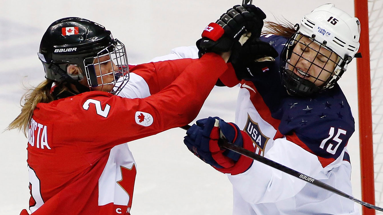 Meghan Agosta-Marciano and Anne Schleper mix it up during the women's gold medal match at Sochi 2014 (AP Photo/Petr David Josek)