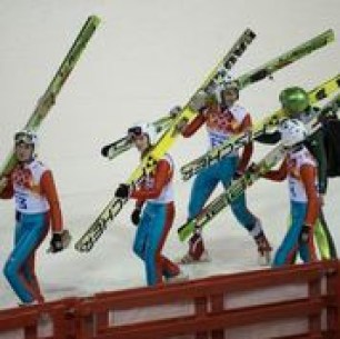 Athletes carrying their skis
