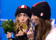 Justine Dufour-Lapointe receives her gold medal and her sister Chloe a silver