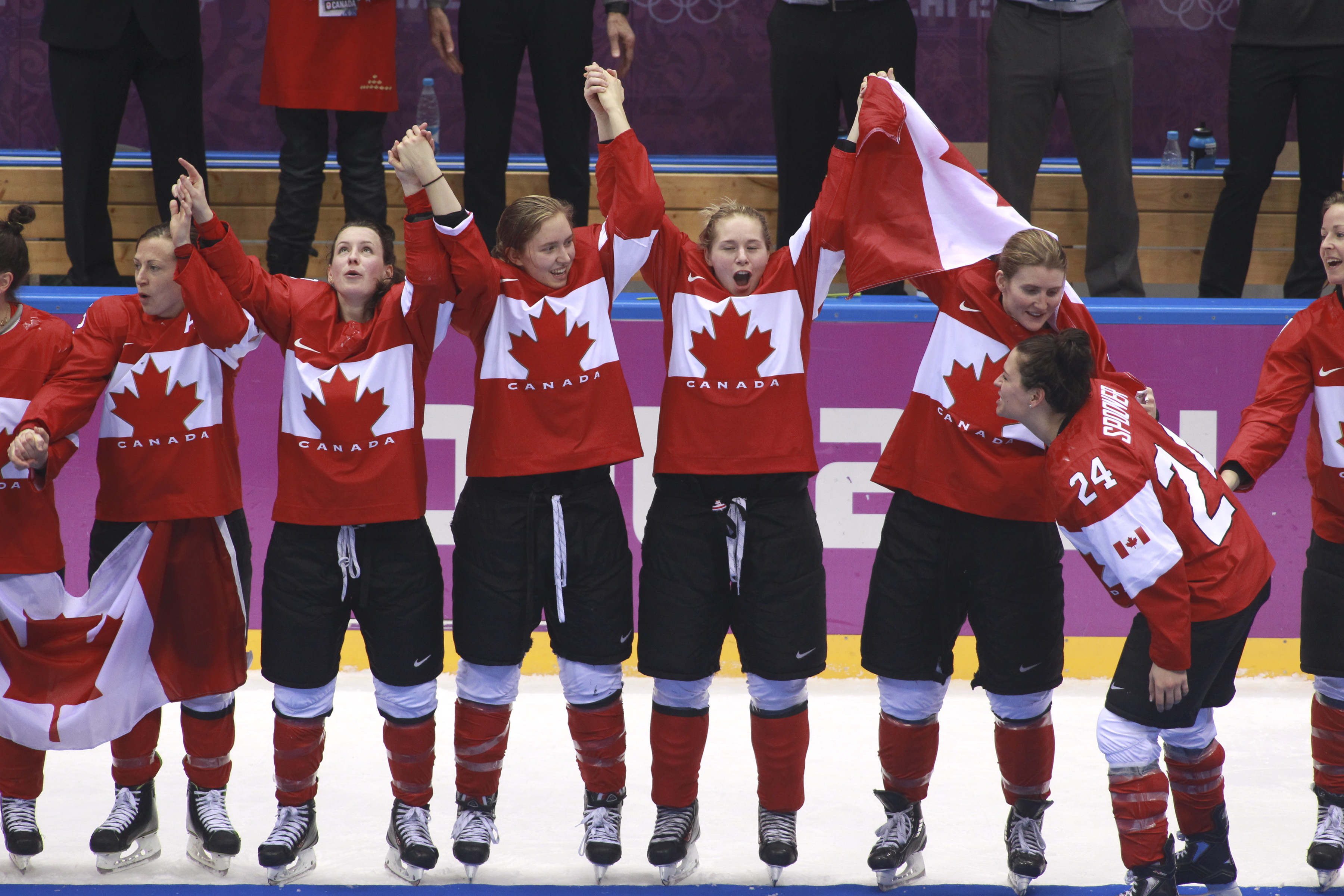 Team Canada celebrates beating Team USA in the gold medal women's hockey match