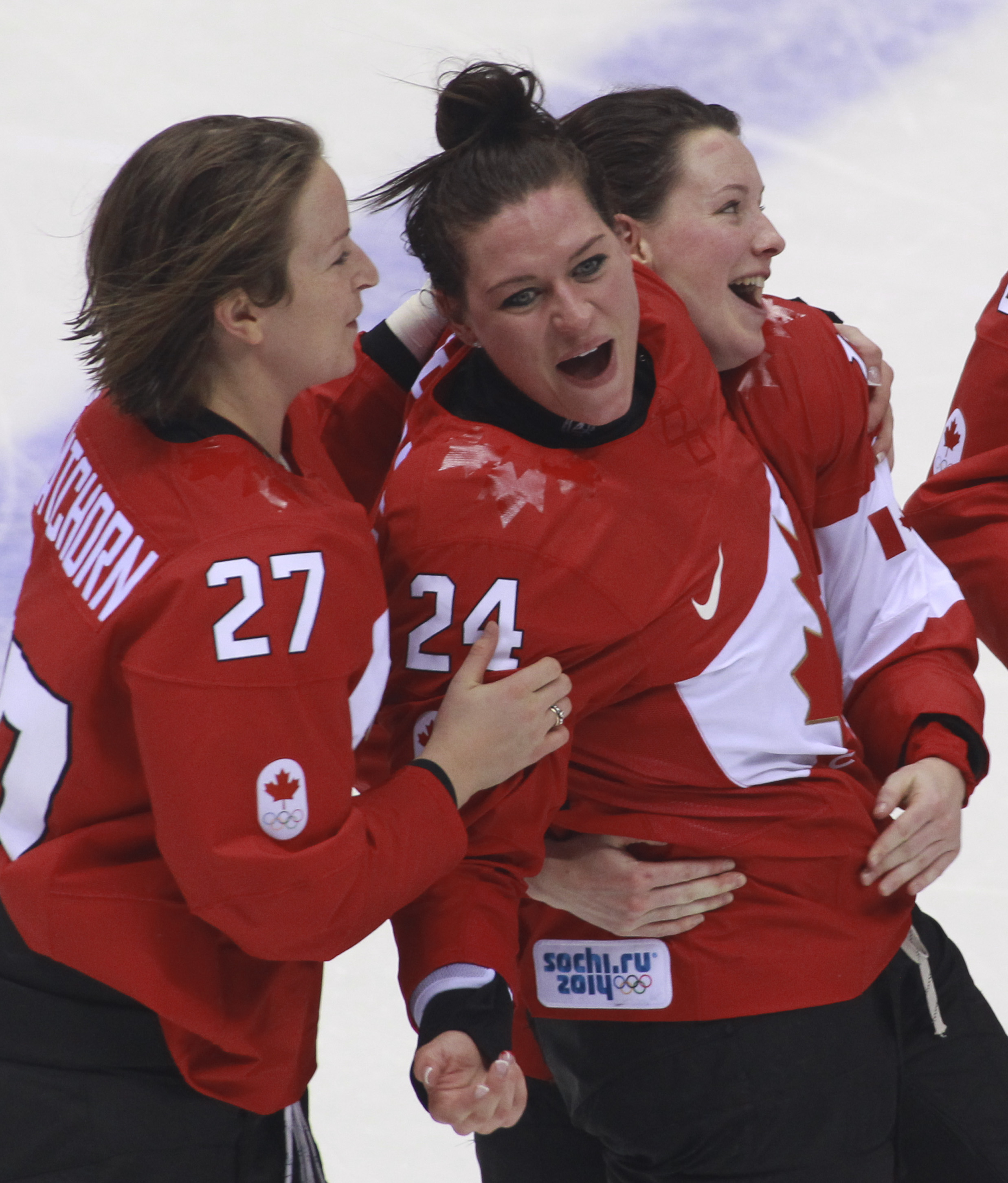 Team Canada celebrates beating Team USA in the gold medal women's hockey match