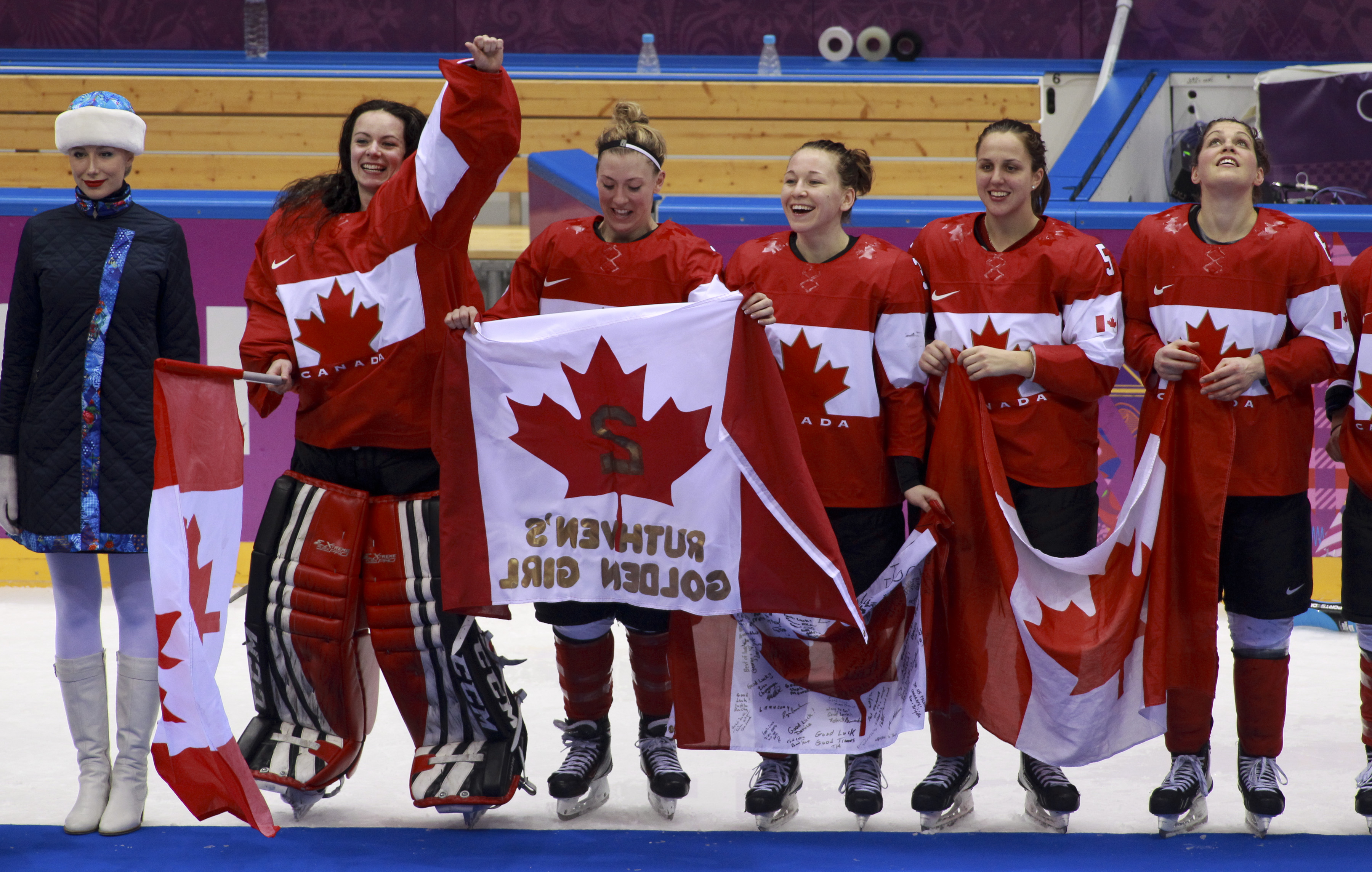 Team Canada celebrates beating Team USA in the gold medal women's hockey match