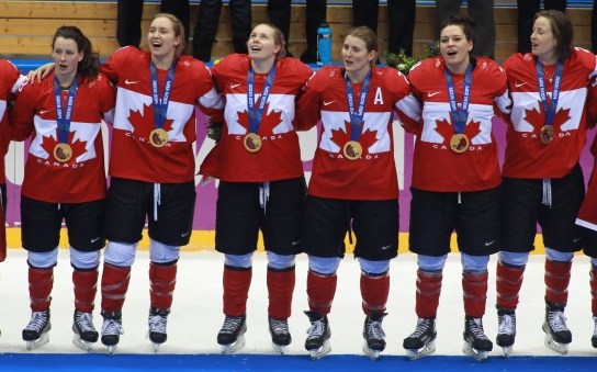 Team Canada celebrates beating Team USA in the gold medal women's hockey match
