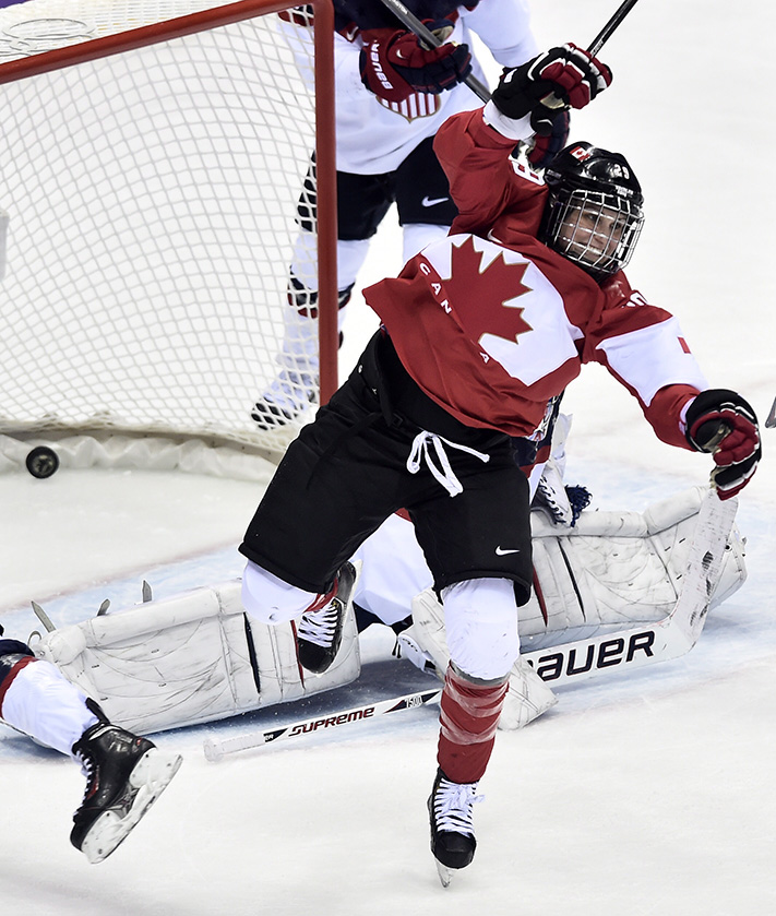 Team Canada celebrates beating Team USA in the gold medal women's hockey match