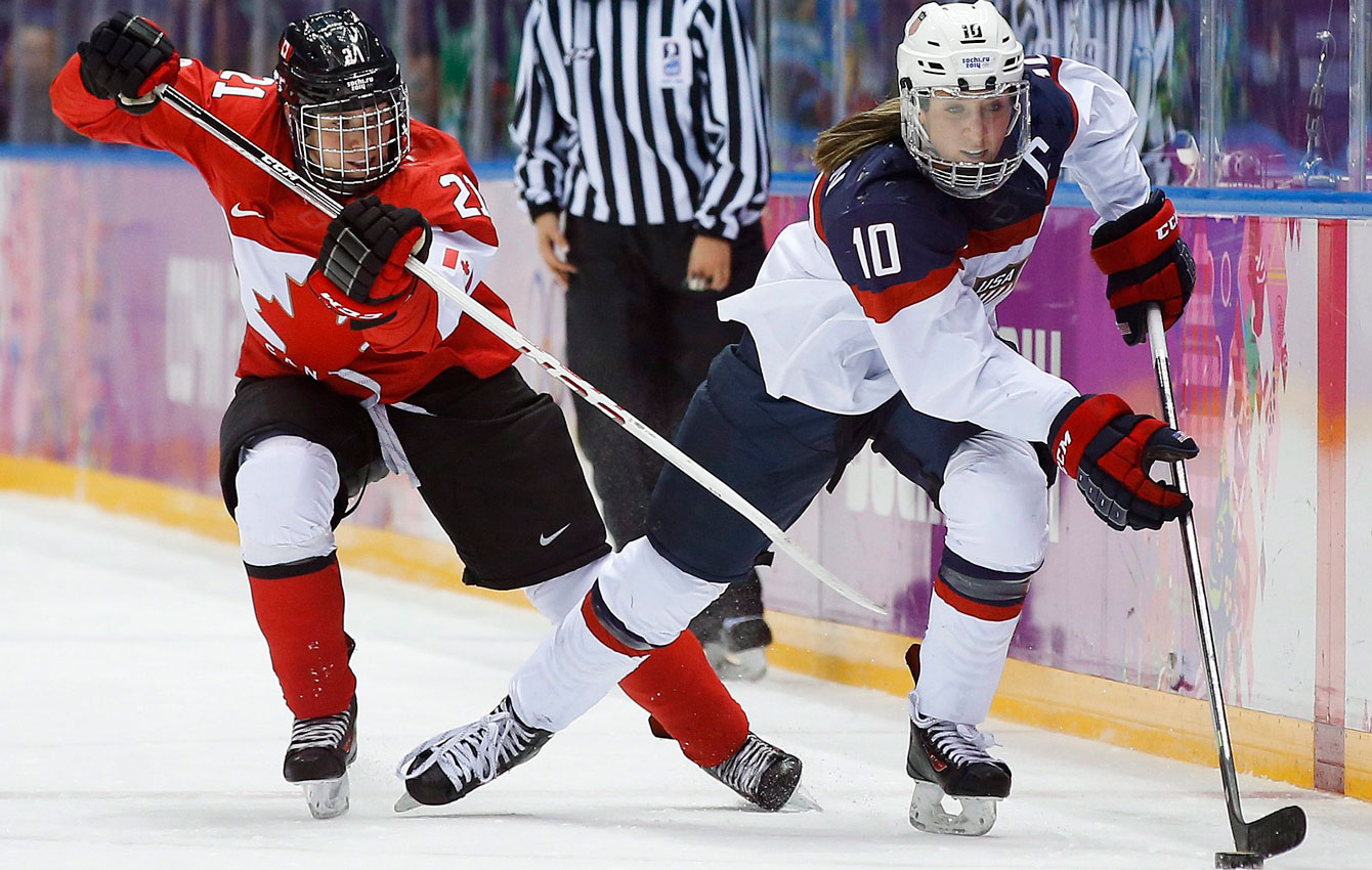 Canada's Haley Irwin battles with Meghan Duggan during the women's gold medal ice hockey game at Sochi 2014 (AP Photo/Matt Slocum)