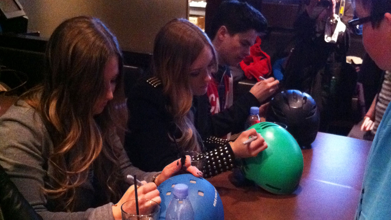 Mikaël joins the Dufour-Lapointe sisters in signing autographs for potential future Olympians. His mother Julie says he calls kids that look up to him "Young Miks."
