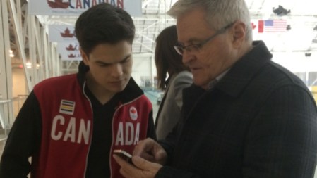 Hockey commentator Bob McKenzie exchanges contact info with Mikaël. They're BFFs now.