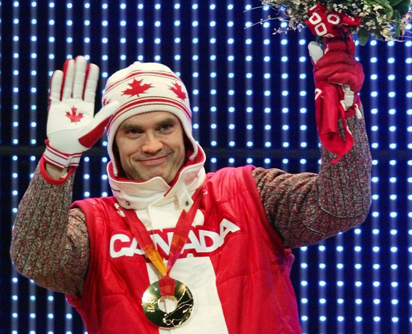 Canada's Duff Gibson celebrates his gold medal during the medal ceremony for the Men's Skeleton competition at the Turin 2006 Olympic Winter Games in Turin, Italy, Saturday Feb 18, 2006. (AP Photo/Greg Baker)
