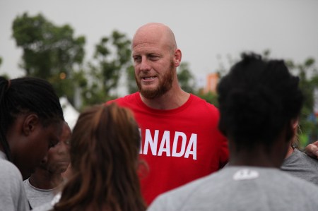 Coach John Tait addresses his team