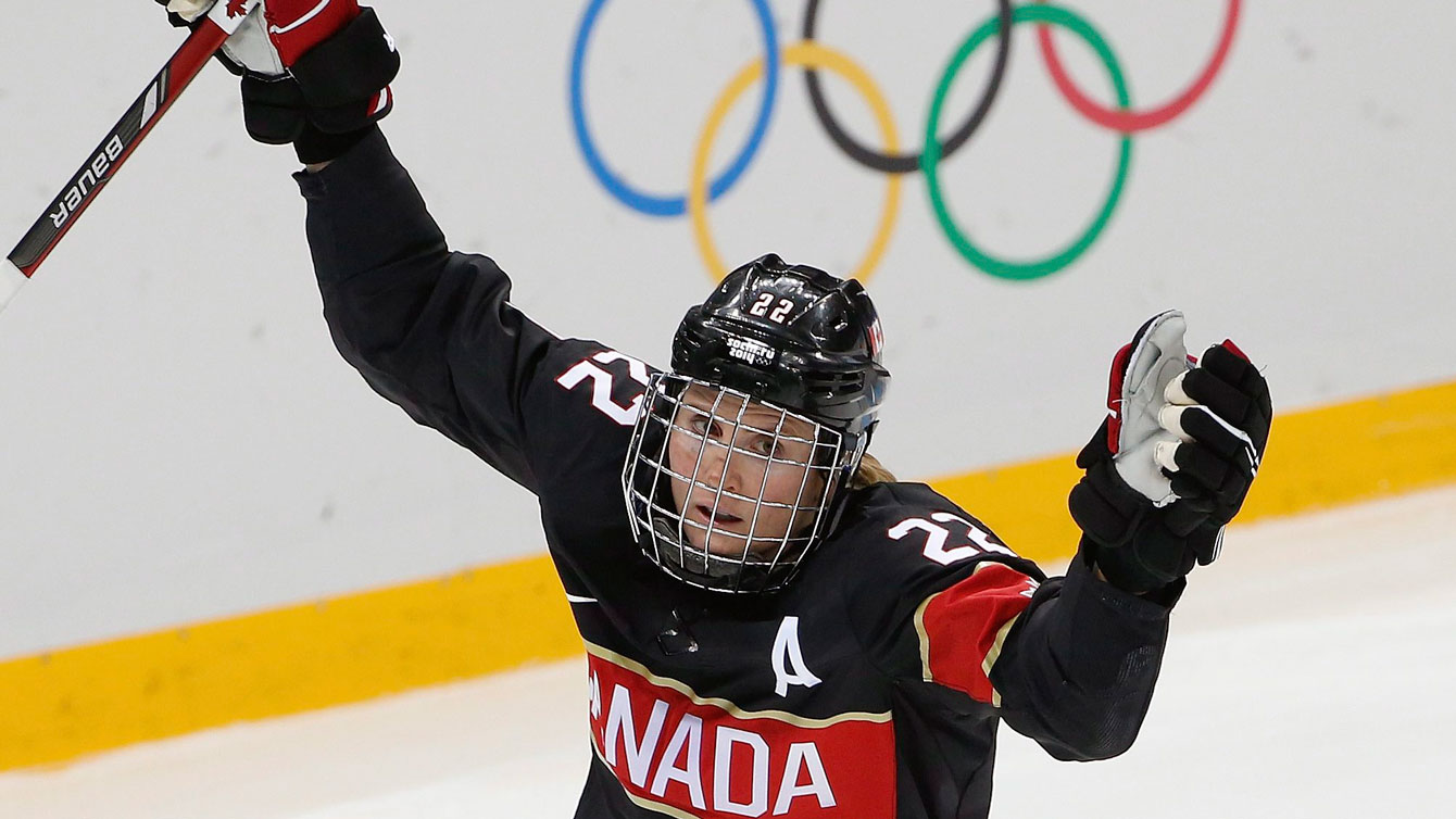 Hayley Wickenheiser raises her arms in celebration 