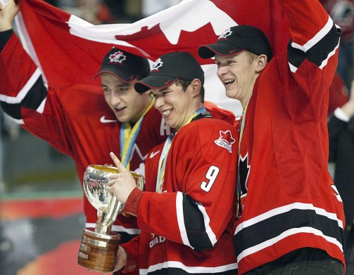 Patrice Bergeron, left, Sidney Crosby, centre, and Corey Perry celebrate their 2005 World Junior Championship gold medal (Photo: CP)