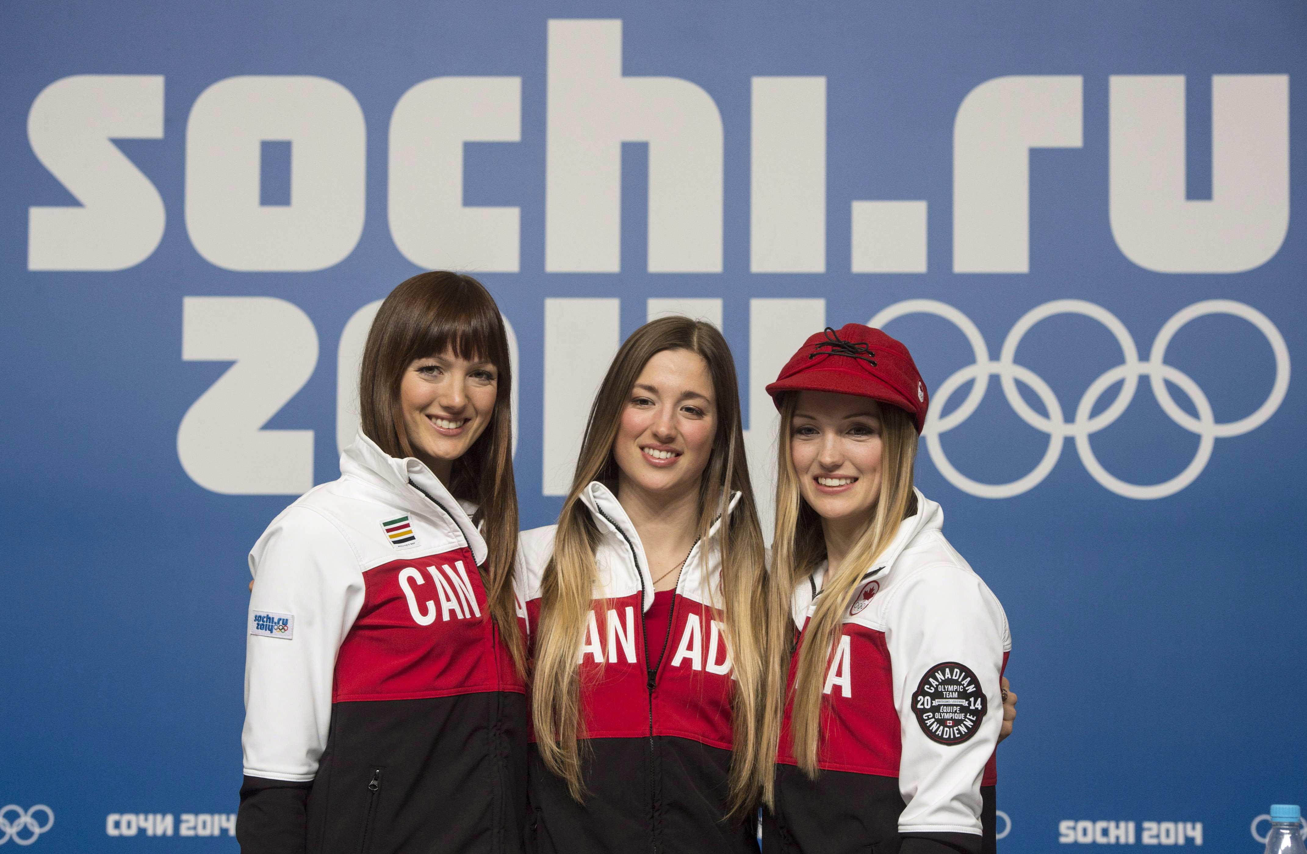 Sisters posing in front of Sochi 2014 Olympic Games sign