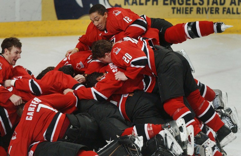 Anthony Stewart (12) lands on the top of the pile as the team celebrates their gold medal victory over Russia (Photo: CP)
