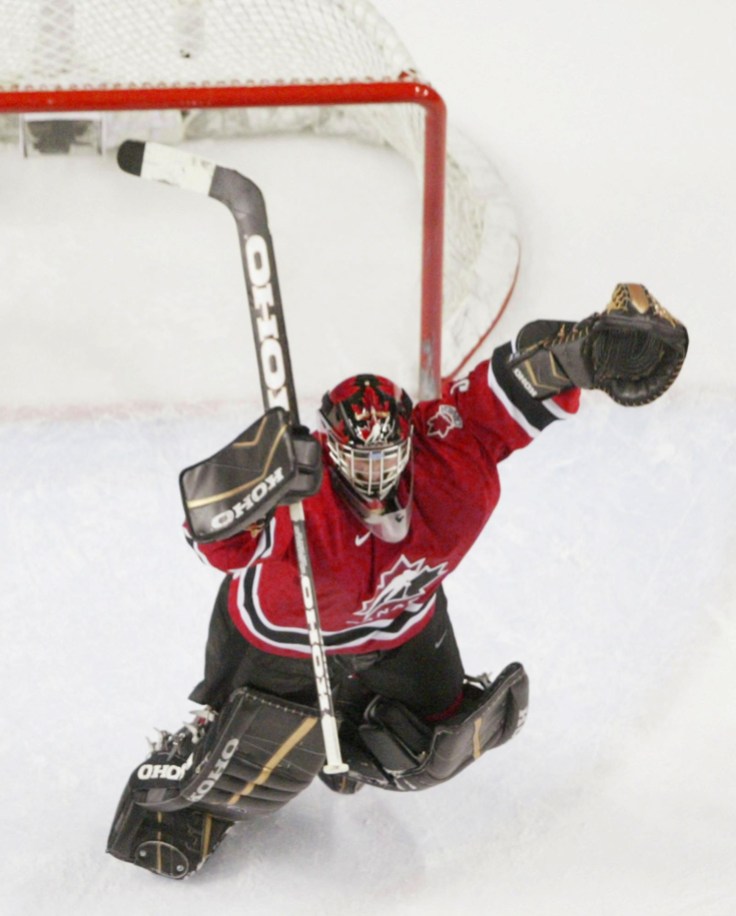 GLASS Goalie Jeff Glass races to celebrate the gold medal win with his teammates (Photo: CP)