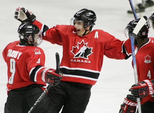 BERGERON/Crosby/BELLE Patrice Bergeron, centre, celebrates a goal with teammates Sidney Crosby, left, and Shawn Belle (Photo: CP)