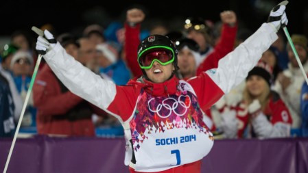 Alex Bilodeau - Sochi 2014 Alex Bilodeau raises his arms after his near-perfect final run, fully aware that he is the man to beat with two skiers to go.