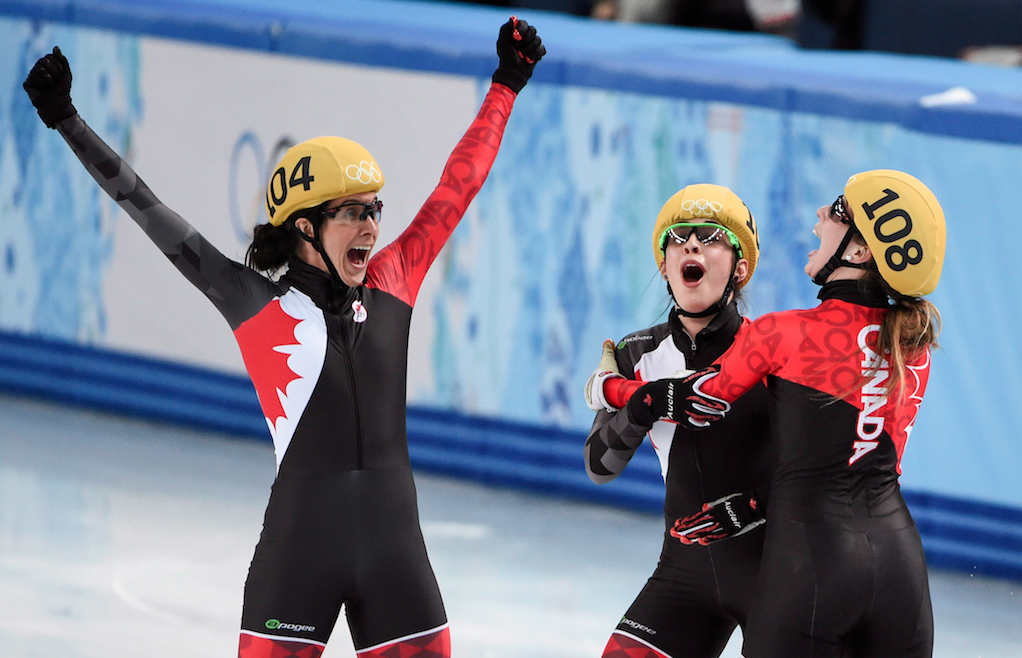 Marie-Ève Drolet (L), Valérie Maltais and Marianne St-Gelais (R) celebrate after China's disqualification announcement earning Canada silver in the women's 3000m relay in Sochi. (Photo: CP)